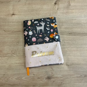 Customizable health record cover in pink double gauze cotton and "forest animal pattern" cotton fabric, gold flex lettering