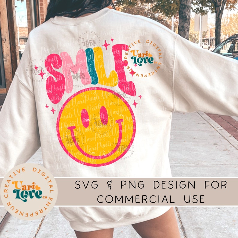 May include: A white sweatshirt with a colorful "SMILE" graphic and a yellow smiley face. The graphic has a distressed, vintage look. The text "Creative Digital Entrepreneur" is on the left sleeve and "Uari Love" is on the right sleeve. The text "SVG & PNG Design for Commercial Use" is at the bottom of the image.