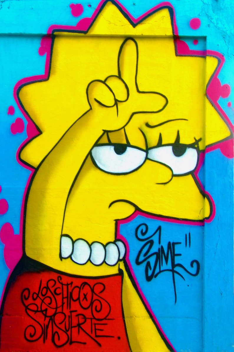 May include: A yellow cartoon character wearing a red shirt and a pearl necklace. The character is making a hand gesture with their right hand. The background is blue with pink and yellow paint splatters. The text "Los Hijos Sin Suerte" and "Zime" are written in black.