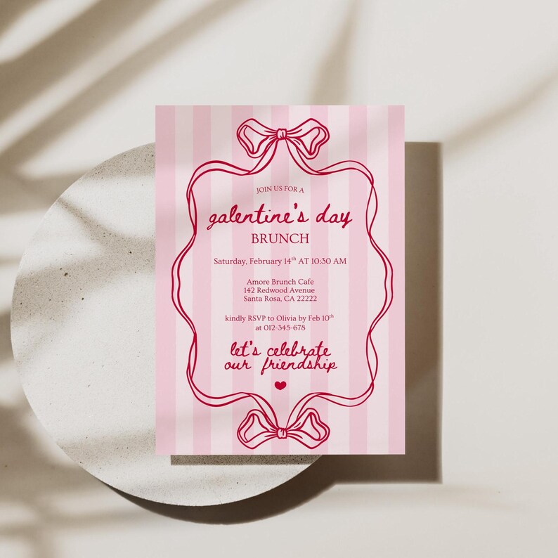 May include: A pink and white striped Galentine's Day brunch invitation. The invitation features a decorative frame with bow accents and the text "Join us for a Galentine's Day Brunch". The invitation includes the date, time, location, and RSVP information.