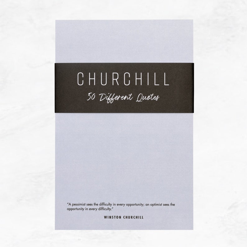 Elusive Blue colored notepad with a black belly band that says: Churchill 50 Different Quotes. A Winston Churchill quot is written across the bottom in a modern font.