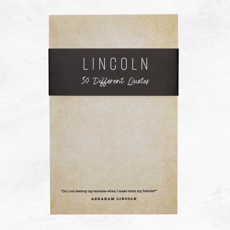 Antique colored notepad with a black belly band that says: Lincoln 50 Different Quotes. An Abraham Lincoln quote about enemies is written across the bottom in a typewriter font.