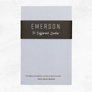 Elusive Blue colored notepad with a black belly band that says: Emerson 50 Different Quotes. A Ralph Waldo Emerson quote about fear is written across the bottom in a modern font.