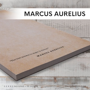 May include: A brown notepad with the quote "The best answer to anger is silence." by Marcus Aurelius. The notepad is 5.5 inches by 8.5 inches and has 50 sheets.