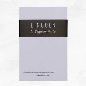 Elusive Blue colored notepad with a black belly band that says: Lincoln 50 Different Quotes. An Abraham Lincoln quote about enemies is written across the bottom in a modern font.