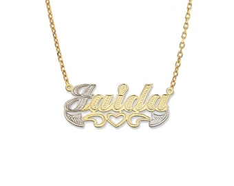 May include: Gold and silver two-tone necklace with the name "Jaidai" spelled out in a cursive font with a heart design.