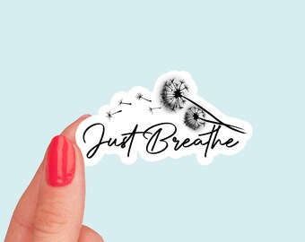 May include: White sticker with black text that says "Just Breathe" and a black silhouette of two dandelions with seeds blowing in the wind.