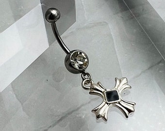 May include: Silver belly button ring with a clear crystal and a silver cross charm with a black center.