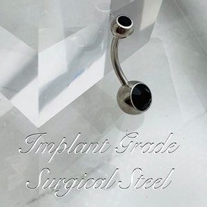 May include: A silver belly button ring with a black gem. The ring is made of implant grade surgical steel.