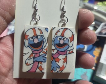 these are some unique recycled earrings featuring vintage paper empherea rescued from a vintage book grover as dare devil  grover