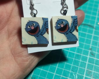these are some unique recycled earrings featuring vintage paper andtheria rescued from a vintage book grover is featured on these