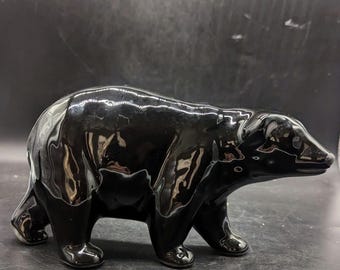 May include: A black ceramic bear figurine. The bear is standing on all fours and has a glossy finish.