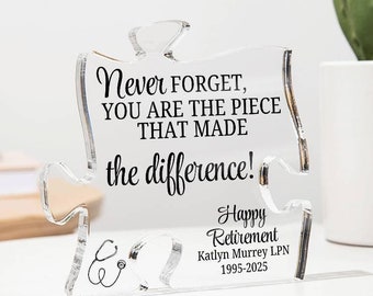 May include: A clear acrylic jigsaw piece with the text "Never FORGET, YOU ARE THE PIECE THAT MADE the difference!" and "Happy Retirement Katlyn Murrey LPN 1995-2025".