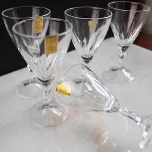 May include: Five clear glass drinking glasses with a diamond pattern. The glasses have gold labels with the text "D.Z.O."