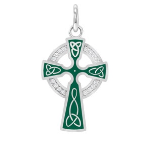 May include: A silver Celtic cross pendant with a green enamel center and a circle of clear cubic zirconia stones.