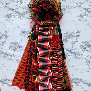 Pre-made Homecoming mum, Garter, red, black, gold homecoming ribbon pin