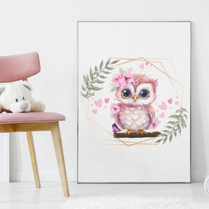 May include: A pink owl with large eyes and a flower crown sits on a branch with a butterfly. The owl is surrounded by pink hearts and green leaves within a gold geometric frame.
