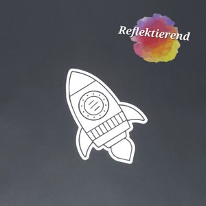Könnte beinhalten: Eine weiße Umrandung eines Raumschiffs mit einem großen Fenster und einer kleinen Flamme, die aus dem Heck kommt. Das Raumschiff befindet sich auf einem schwarzen Hintergrund. Der Text "Reflektierend" befindet sich in der oberen rechten Ecke des Bildes.