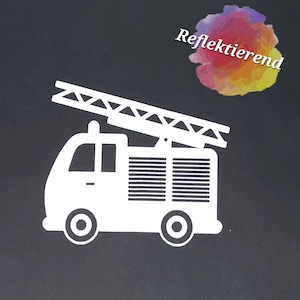 Könnte beinhalten: Weiße Silhouette eines Feuerwehrautos mit einer Leiter auf dem Dach. Das Auto hat einen schwarzen Hintergrund und die Worte "Reflektierend" sind in einer bunten Aquarellschrift über dem Auto geschrieben.