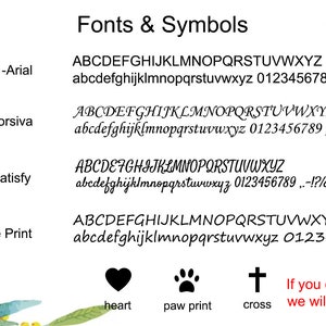 May include: A white background with purple flowers on the left and right sides. The text 'Fonts & Symbols' is at the top of the image. Below the text are four different fonts with the font name and a sample of the font. The fonts are Arial, Monotype Corsiva, Satisfy, and Segoe Print. Below the fonts are three symbols: a heart, a paw print, and a cross. The text 'heart', 'paw print', and 'cross' are below the symbols. The text 'If you don't choose a font, we will use Font 1 for you.' is below the symbols.