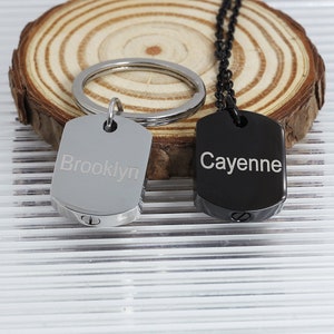 May include: Two silver and black dog tag keychains with engraved names 'Brooklyn' and 'Cayenne'.