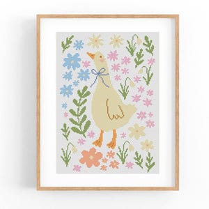 May include: Cross stitch pattern featuring a yellow duck with a blue bow, surrounded by pink, blue and green flowers.