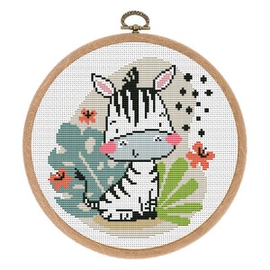 May include: A cross-stitch embroidery hoop featuring a charming cartoon zebra in a jungle scene. The zebra is black and white with a grey face and pink cheeks. The background is a white canvas with green leaves and orange flowers.