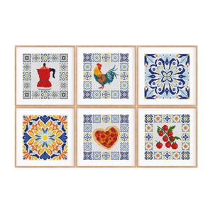 May include: A set of six square framed cross-stitch patterns featuring Mediterranean-inspired motifs. The designs include a red moka pot, a colorful rooster, a blue and white tile pattern, an orange floral tile, a heart-shaped pizza, and red tomatoes.