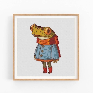 May include: A cross-stitch pattern featuring a cartoon frog wearing a blue jacket, orange scarf, and red boots.