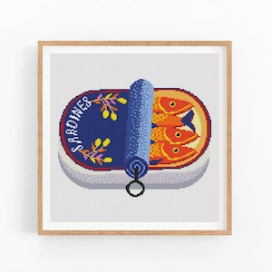 May include: A cross-stitch pattern of a blue and red can of sardines with the word "SARDINES" printed on the side. The can is open and three red fish are visible inside.