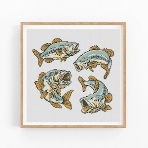 May include: A framed print showing four stylized fish illustrations. The fish are in shades of blue, tan, and yellow, with open mouths and detailed scales. The artwork is set against a light grey background, and the frame is a light brown colour.