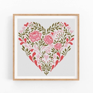 May include: A cross-stitch pattern of a heart-shaped floral design with pink and red flowers and green leaves.