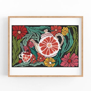 May include: A framed cross-stitch art piece featuring a teapot and teacup with a floral design. The teapot and teacup have red and white accents. The background is black with red, pink, yellow, and green flowers and foliage.