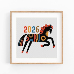 May include: A framed print featuring a stylized horse design. The horse is black with colorful accents, including orange, blue, and yellow. The number "2026" is displayed above the horse in orange, yellow, and brown. The artwork is set against a white background.