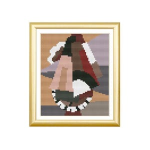 May include: A framed cross-stitch embroidery featuring an abstract geometric composition. The design consists of interlocking shapes in shades of tan, dark brown, deep red, white, and muted purple, all contained within a metallic gold-toned frame.