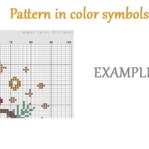 May include: A cross stitch pattern with a grid of 100 squares. The pattern features a brown branch with green leaves, red flowers, and gold stars. The text "Happy Cross Stitchers" is at the top of the grid.