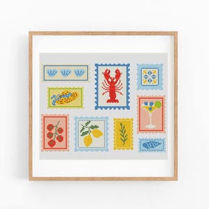 May include: A framed cross-stitch artwork featuring various colorful stamp designs. The stamps depict a lobster, lemons, cherries, a cocktail, and other food-related images. The artwork is set against a white background.