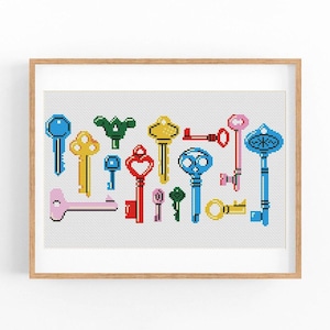 May include: A framed cross-stitch artwork featuring a collection of colorful keys. The keys are in various shapes and sizes, with colors including blue, yellow, green, red, pink, and gold. The artwork is set against a white background.