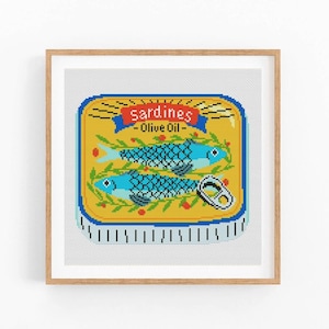 May include: A yellow and blue illustration of a can of sardines in olive oil. The can has a red and white label with the text "Sardines - Olive Oil".
