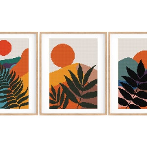 Peut inclure: Trois impressions encadrées avec un design géométrique minimaliste représentant un coucher de soleil stylisé, des montagnes et une seule feuille en silhouette noire. Les impressions ont une palette de couleurs chaudes d'orange, jaune, marron, bleu sarcelle et violet.