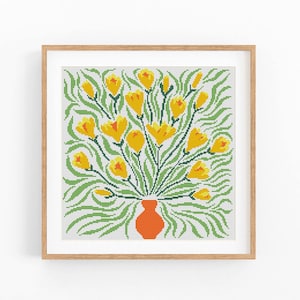 May include: Cross stitch pattern of a vase filled with yellow flowers with orange centers. The vase is orange and the background is white.