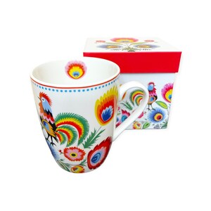 May include: A white ceramic mug with a colorful rooster and floral design. The mug comes in a white gift box with a red lid and a similar design.