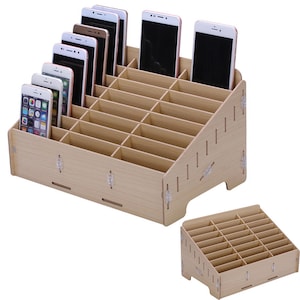 May include: A wooden phone stand with 18 slots for storing and charging phones. The stand is made of light brown wood and has a slanted design.