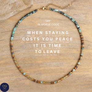May include: A beaded necklace with a gold chain and clasp. The necklace features a variety of small, colorful beads in shades of brown, turquoise, and gold. Text on the image reads "Say in Morse Code When Staying Costs You Peace It Is Time To Leave."