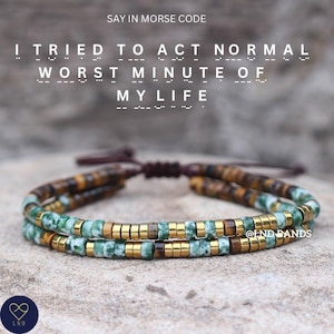 May include: Two-strand beaded bracelet with green, brown, and gold beads. The text "I TRIED TO ACT NORMAL WORST MINUTE OF MY LIFE" is above the bracelet in Morse code. The brand name "LND" is at the bottom.