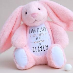 May include: Pink plush bunny rabbit with embroidered text that reads "Hand Picked For Earth By My Grandma In Heaven".