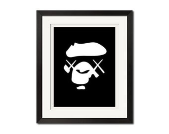 May include: Black and white framed print of a stylized cartoon face with X's for eyes.