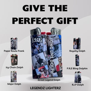 May include: A set of ten collectible lighters featuring different designs with images of rapper Young Dolph. The lighters are all black and have a silver top. The lighters are arranged in a grid pattern on a white background. The text "LEGENDZ LIGHTERZ" is printed below the lighters.