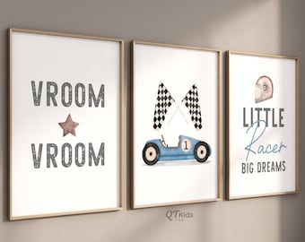 May include: Three framed prints with a racing theme. The first print has the text "VROOM" in gray with a brown star in between the words. The second print has a blue race car with a checkered flag behind it. The third print has the text "LITTLE Racer BIG DREAMS" in gray with a red racing helmet above the text.