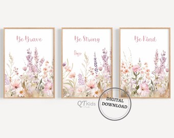 May include: Three framed art prints with floral watercolor designs. Each print features a different phrase in pink script: "Be Brave," "Be Strong," and "Be Kind." The artwork includes pink, purple, and peach flowers with green foliage. The prints are labeled "DIGITAL DOWNLOAD."